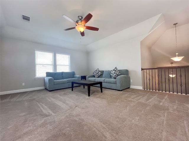 carpeted living room featuring ceiling fan and vaulted ceiling