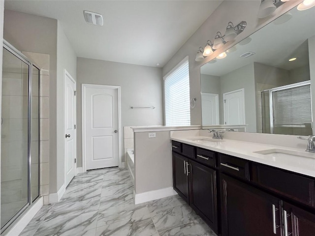 6008 Genova Pl, Round Rock, TX 78665 - bathroom with marble finish floors, a shower stall, double vanity, and a garden tub