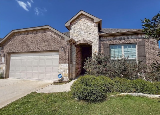 6008 Genova Pl, Round Rock, TX 78665 - french provincial home featuring stone siding, a garage, brick siding, concrete driveway, and a shingled roof