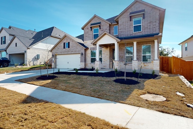 view of front of home with a front yard, a porch, and a garage