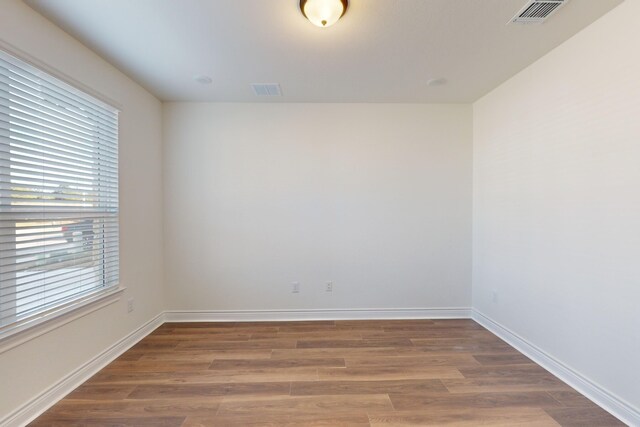 spare room featuring wood-type flooring