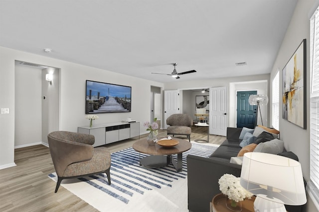 living room featuring light hardwood / wood-style floors and ceiling fan