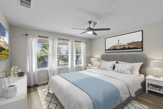 bedroom with ceiling fan and light hardwood / wood-style floors