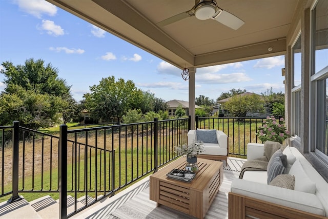 balcony featuring an outdoor living space and ceiling fan