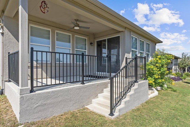 property entrance featuring a lawn and ceiling fan