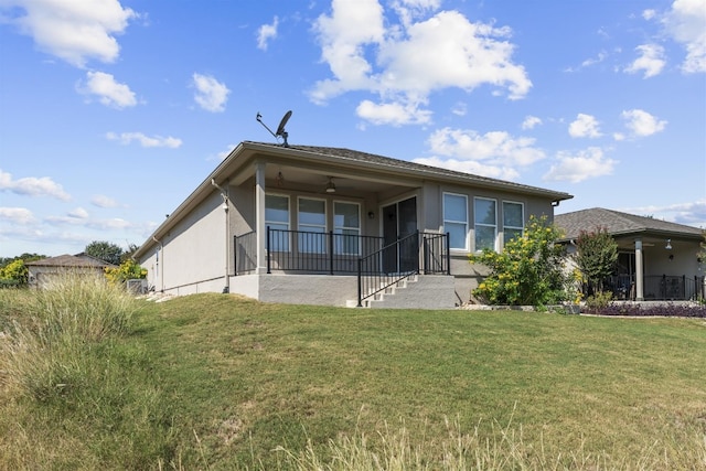 back of property featuring a patio, a lawn, and ceiling fan