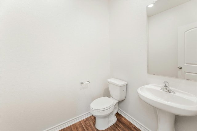 bathroom featuring sink, hardwood / wood-style flooring, and toilet