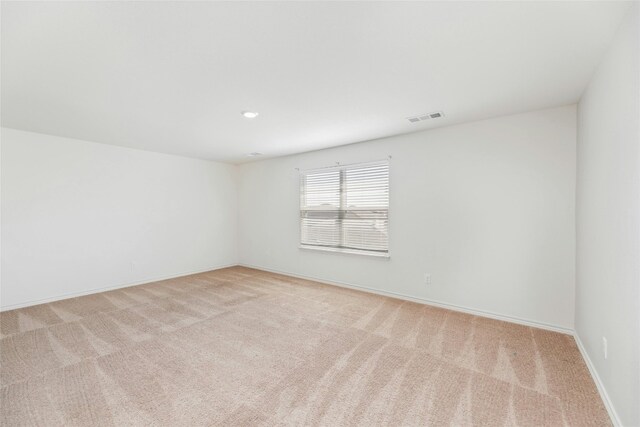 unfurnished room with light colored carpet