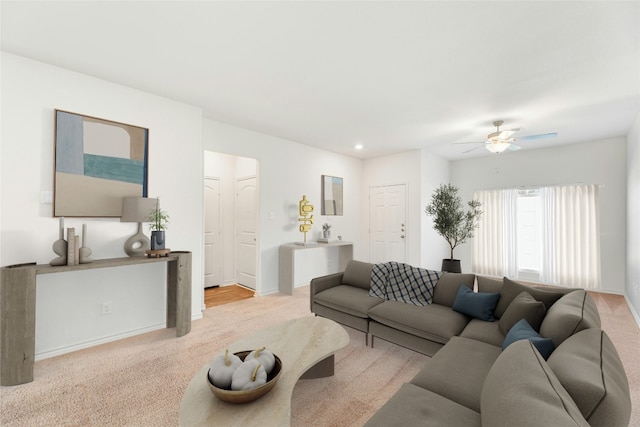 carpeted living room with ceiling fan