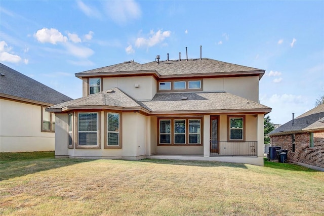 3317 Venezia Vw, Leander, TX 78641 - rear view of house featuring stucco siding, a yard, a shingled roof, and central AC