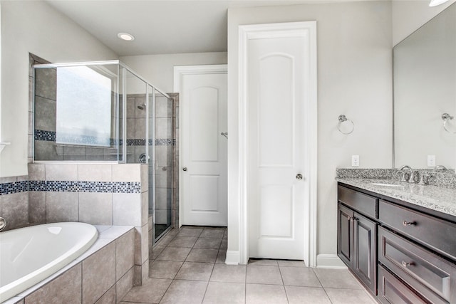 bathroom featuring vanity, tile patterned flooring, and plus walk in shower