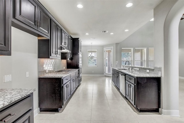 3317 Venezia Vw, Leander, TX 78641 - kitchen featuring a sink, appliances with stainless steel finishes, baseboards, tasteful backsplash, and light stone counters