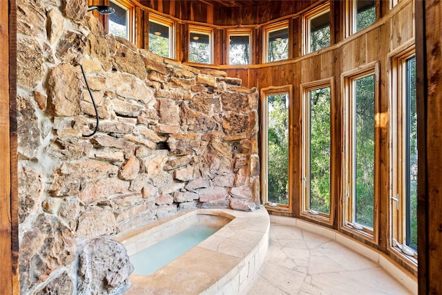 bathroom featuring wooden walls