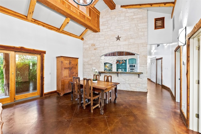 dining room featuring beam ceiling and high vaulted ceiling