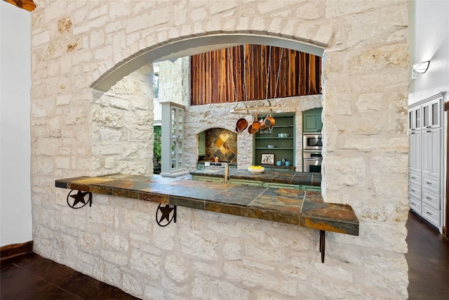 bar with appliances with stainless steel finishes and a fireplace