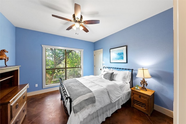 bedroom with ceiling fan and dark tile patterned flooring