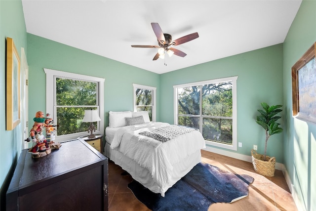 bedroom featuring dark tile patterned floors and ceiling fan