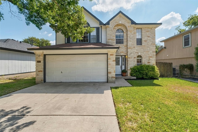 view of front property featuring a garage and a front yard