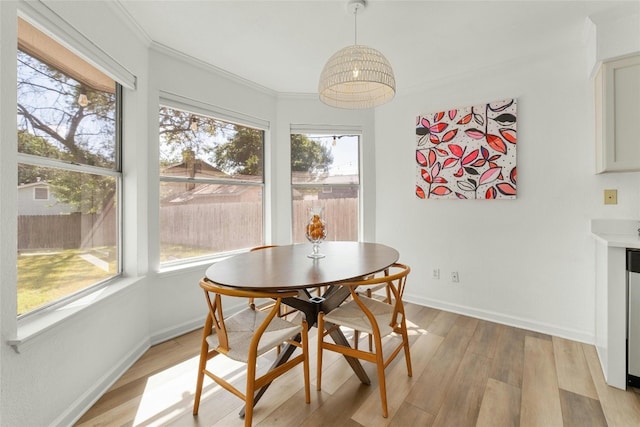 interior space with plenty of natural light, light wood-type flooring, and crown molding