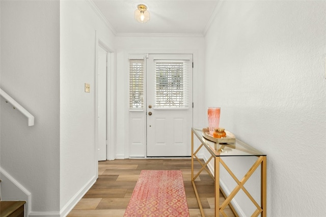 entryway featuring light hardwood / wood-style floors and crown molding