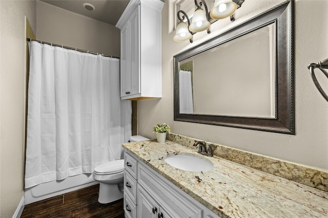 bathroom featuring toilet, wood finished floors, vanity, and shower / tub combo with curtain