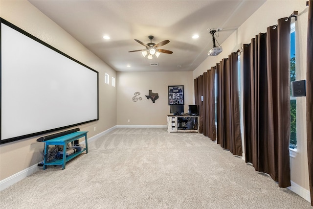 home theater with a ceiling fan, recessed lighting, light colored carpet, and baseboards