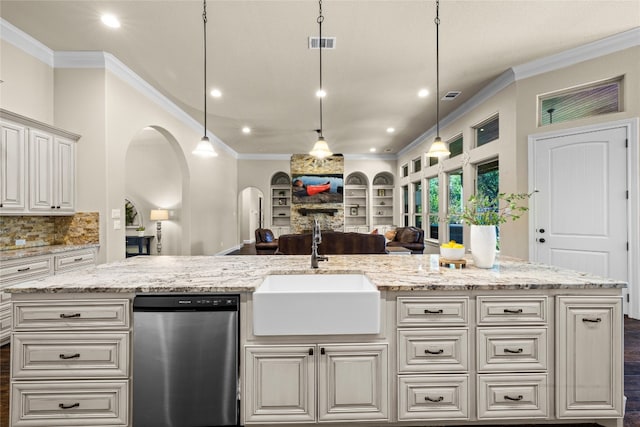 kitchen with visible vents, hanging light fixtures, stainless steel dishwasher, open floor plan, and a sink