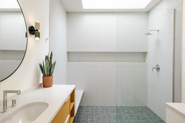 2112 Lawnmont Ave, Austin, TX 78756 - bathroom with a tile shower, vanity, and a skylight