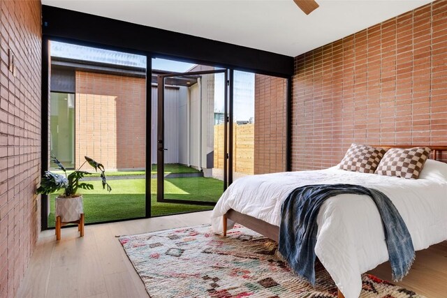 2112 Lawnmont Ave, Austin, TX 78756 - bedroom featuring access to outside, wood finished floors, and a wall of windows