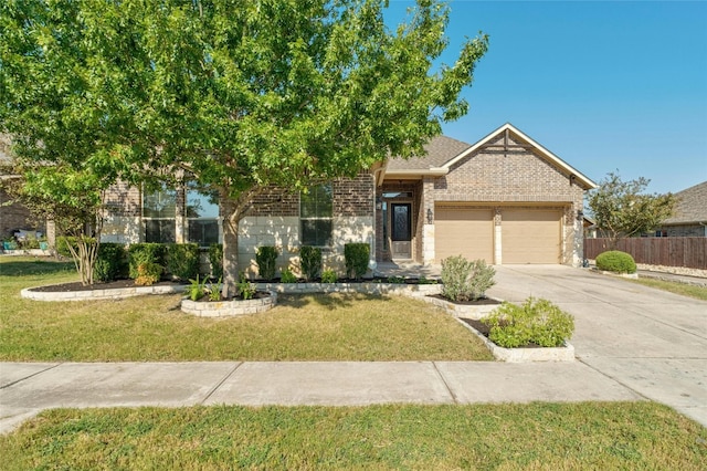 view of property hidden behind natural elements featuring a front yard and a garage