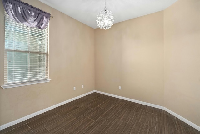 spare room with a chandelier