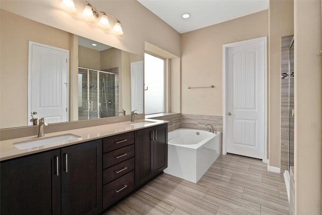 bathroom with vanity and independent shower and bath