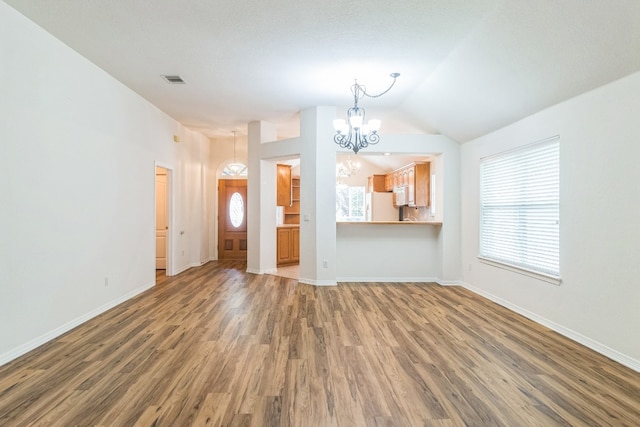 unfurnished living room with plenty of natural light and hardwood / wood-style floors