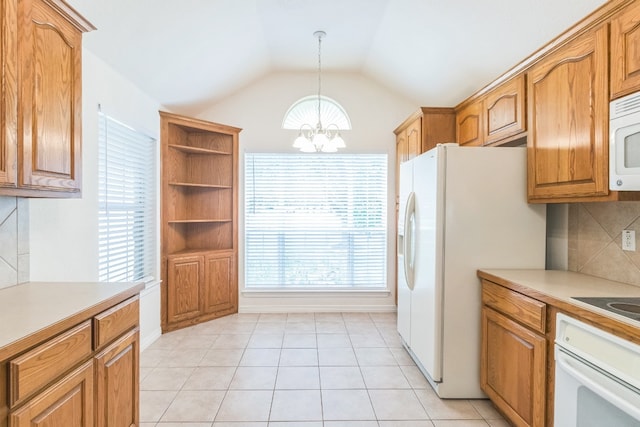 kitchen featuring a notable chandelier, a healthy amount of sunlight, white appliances, and decorative light fixtures