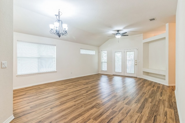 interior space featuring vaulted ceiling, ceiling fan with notable chandelier, and hardwood / wood-style floors