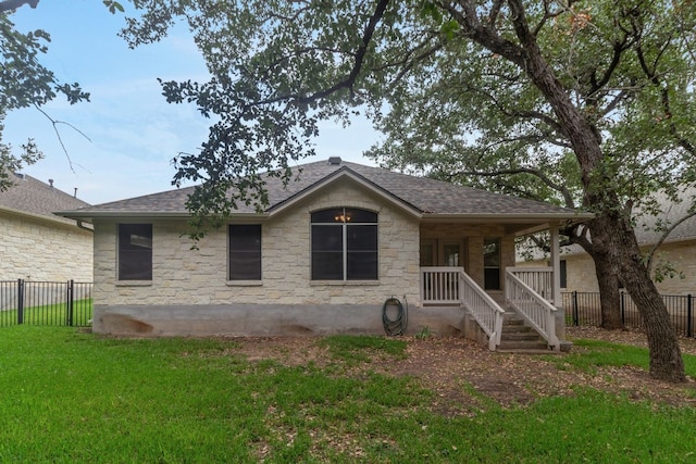 back of house with a yard and covered porch