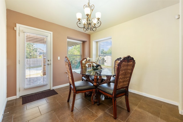 tiled dining space with a chandelier