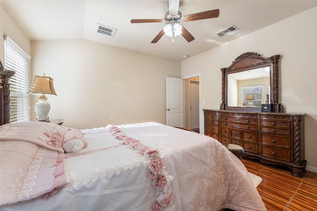 bedroom with ceiling fan, dark hardwood / wood-style floors, and vaulted ceiling