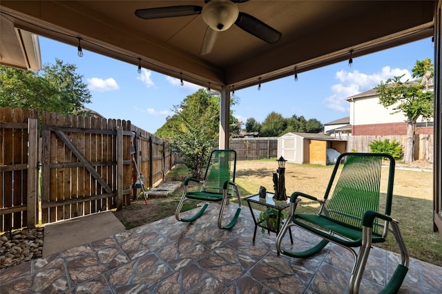 view of patio / terrace with ceiling fan and a storage shed