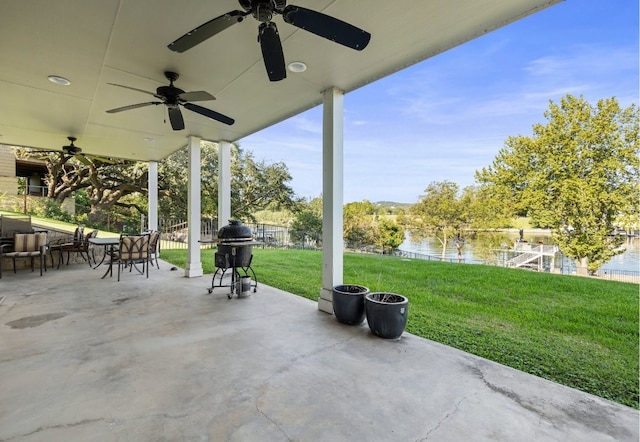 view of patio / terrace with ceiling fan and a water view