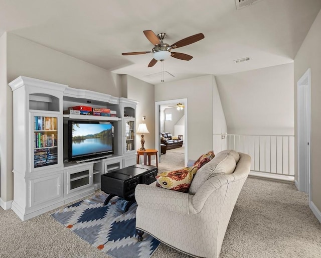 living room featuring ceiling fan, carpet floors, and vaulted ceiling