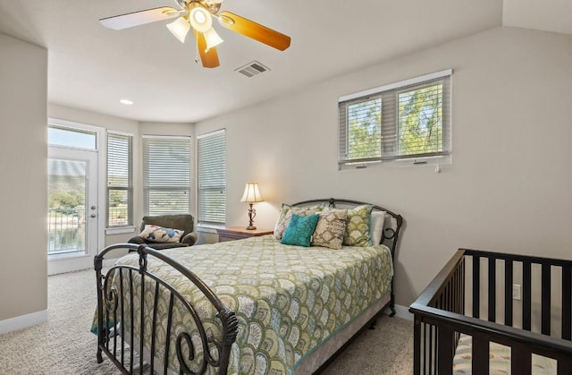 bedroom featuring ceiling fan, carpet floors, and multiple windows