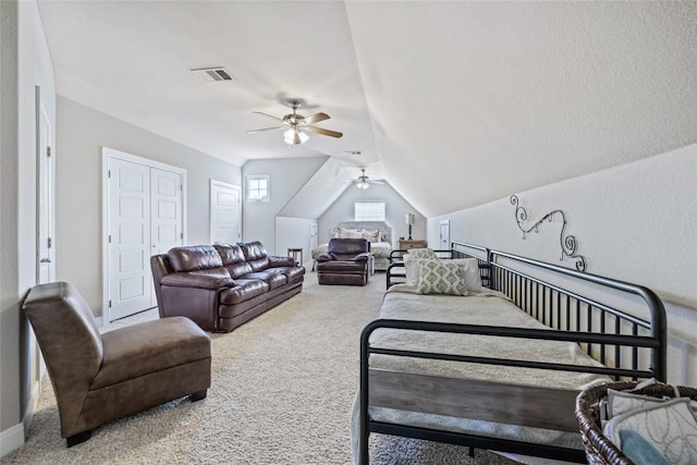 living room featuring ceiling fan, lofted ceiling, and carpet floors