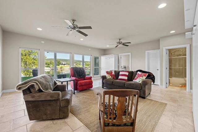 tiled living room with ceiling fan