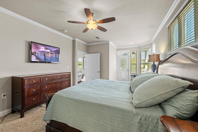 carpeted bedroom featuring multiple windows, ceiling fan, and crown molding