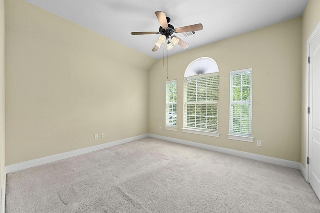 carpeted spare room with ceiling fan and lofted ceiling