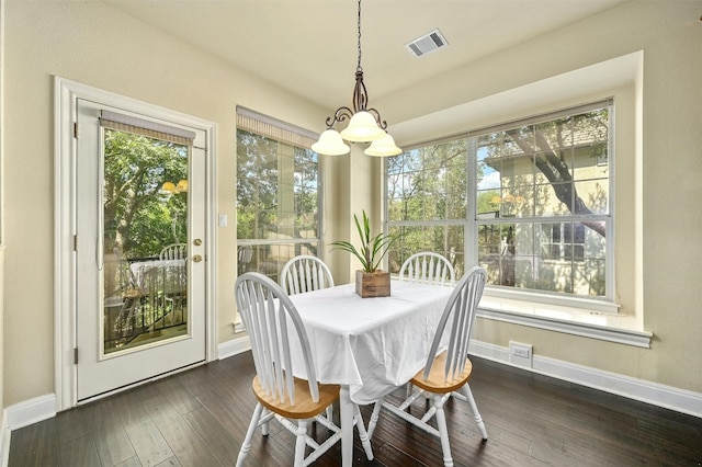 dining space featuring dark wood-type flooring