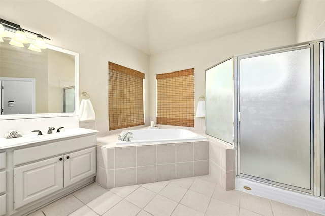 bathroom featuring tile patterned flooring, shower with separate bathtub, and vanity