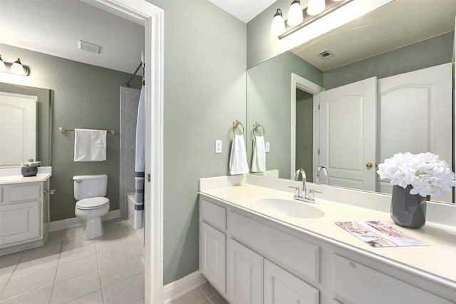 bathroom featuring tile patterned flooring, vanity, and toilet