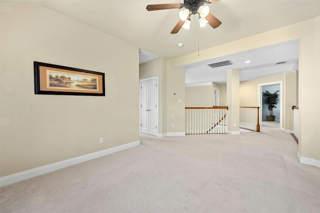 empty room with ceiling fan and light colored carpet